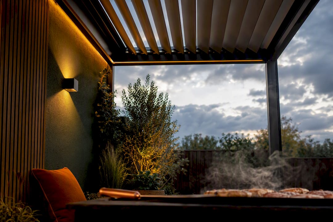 Louvred roof sheltering an outdoor cooking area